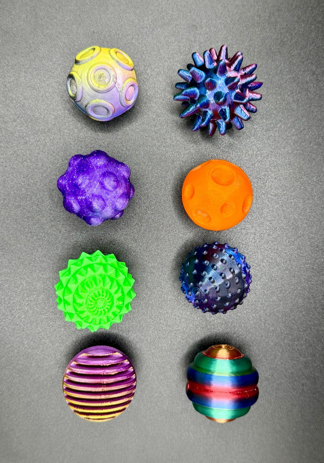 3D Printed Orb Collection – Set of 8 Textured Interactive Balls featuring unique surface patterns and vibrant colors.